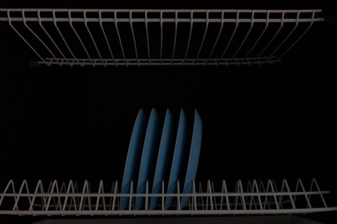 Dishwasher racks containing blue plates
